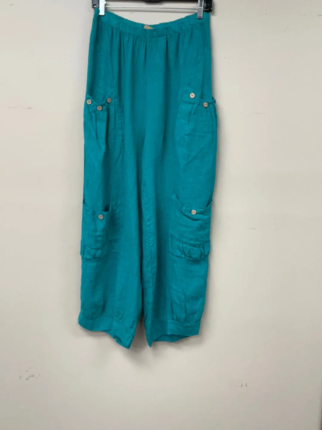 Four pocket Italian linen pants with button accent.